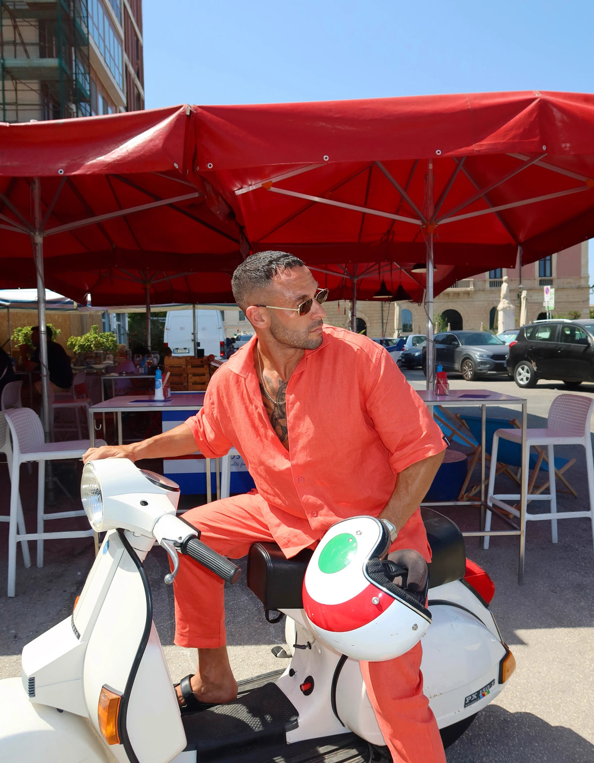 Coral men's linen set on a Vespa at the market, We Hustle