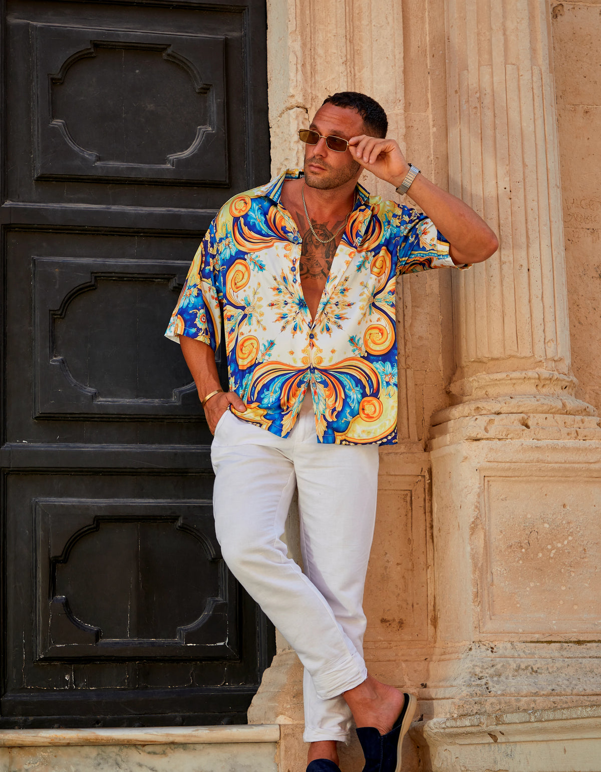 Positano men's satin Cuban collar shirt with white trousers on stone steps, We Hustle