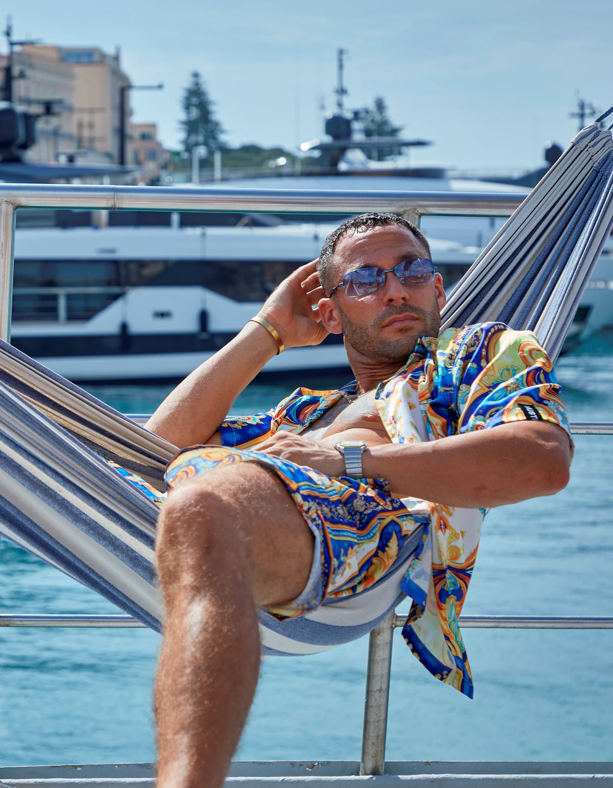 Positano men's satin shirt and swim short set in a hammock, yachts behind, We Hustle