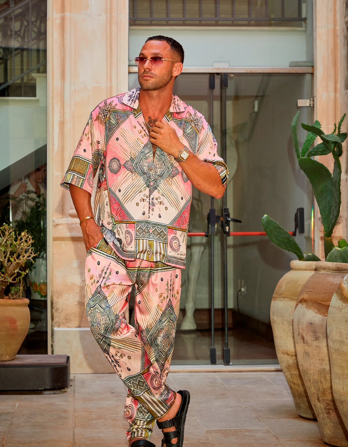 Scar City men's satin shirt worn as the co-ord set in the courtyard, We Hustle