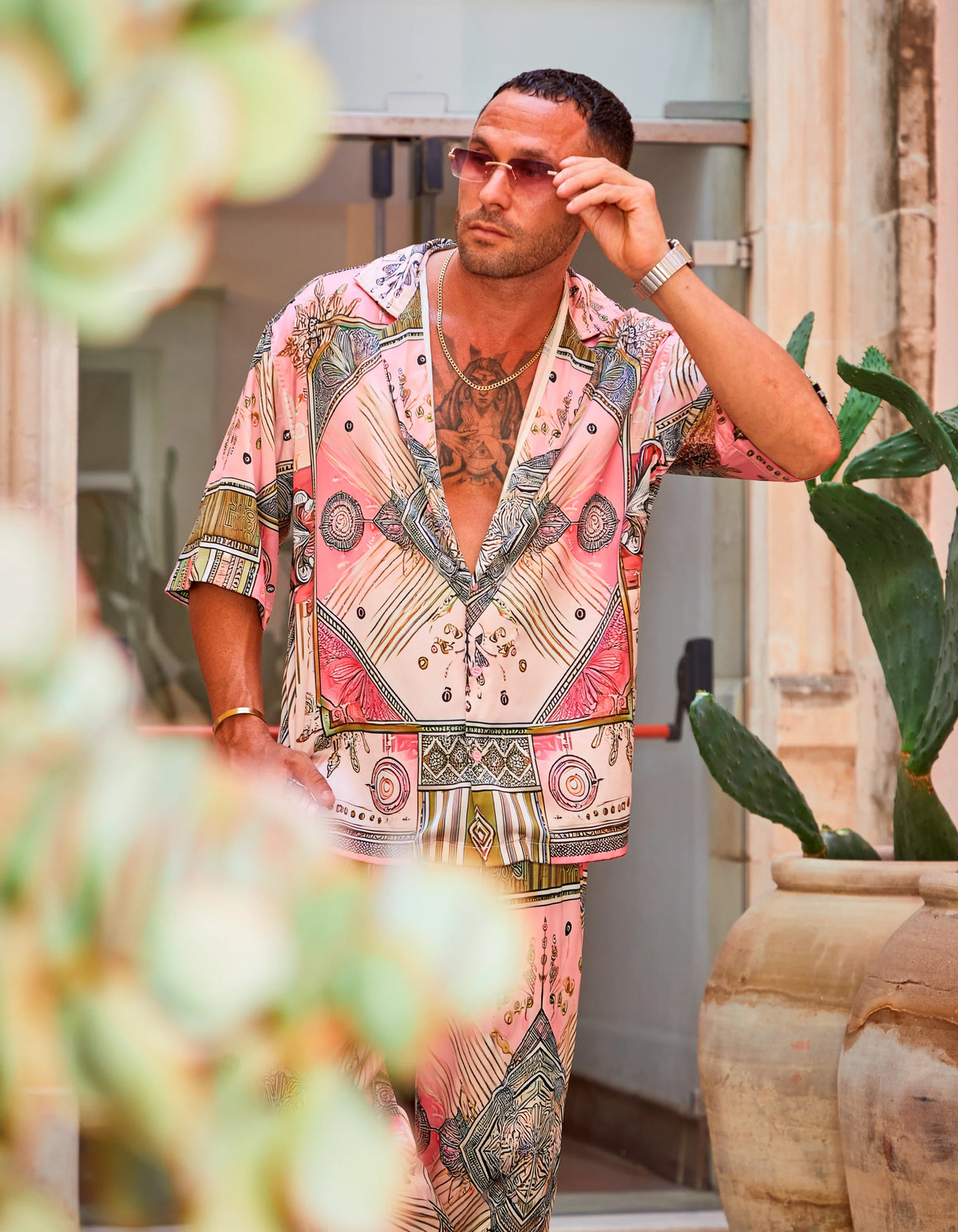 Scar City men's satin shirt, print detail with sunglasses in the courtyard, We Hustle