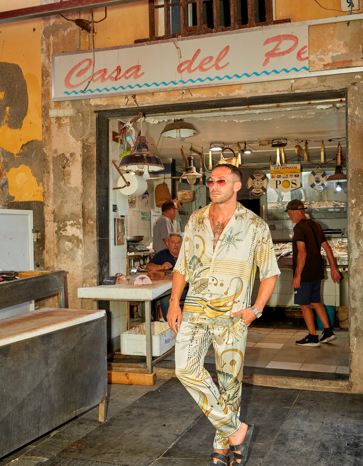 South Beach men's satin co-ord set in the fish market doorway, We Hustle